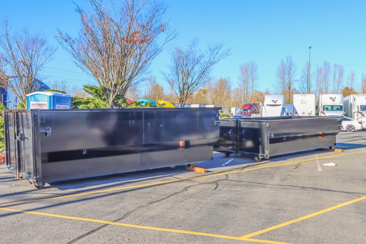 Professional dumpster rental service with roll-off container on residential driveway in Arcadia